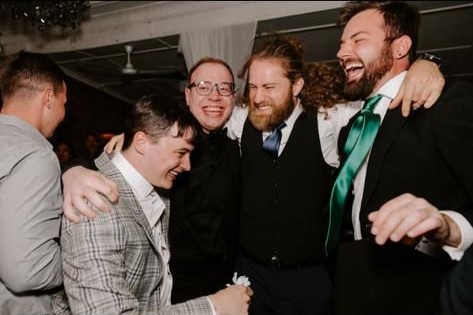 Guests laughing together on the dance floor