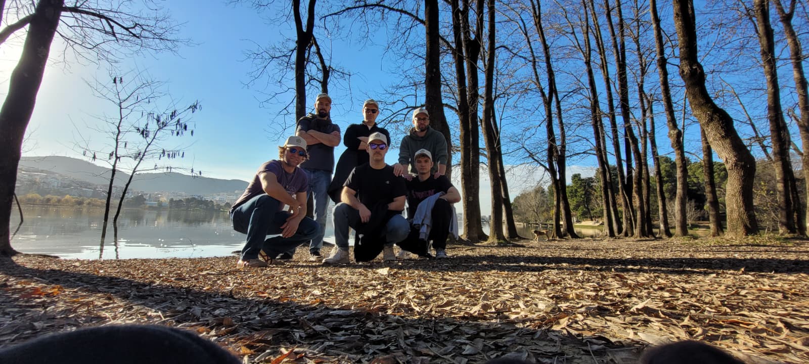 The six executives gathered beneath bare trees beside a lake
